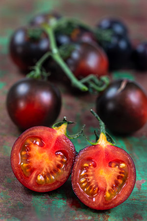 Tomato Yoom in macro sliced in half, in front of the cluster.の写真素材