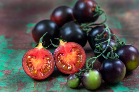 Tomato Yoom in macro sliced in half, in the center of the cluster.の写真素材