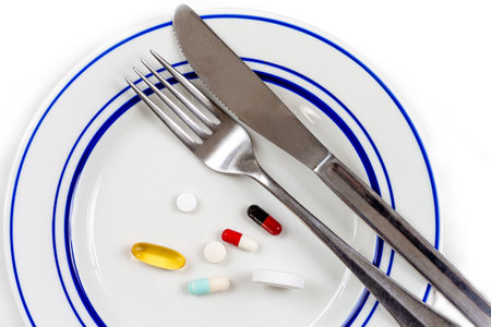 Overmedication -Capsules and hidden in a close-up plate with the broods.の写真素材