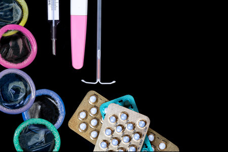 Contraceptives seen from above on a black background.の写真素材