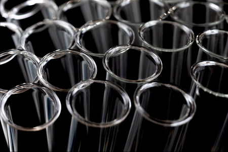 Closeup of empty glass test tubes on a black background in laboratory..の写真素材