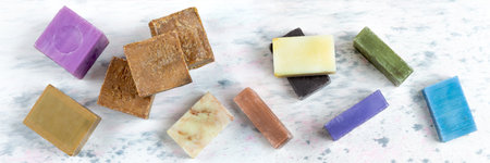 panoramic Homemade soaps. Variety of colorful handmade soap bars on wooden background
