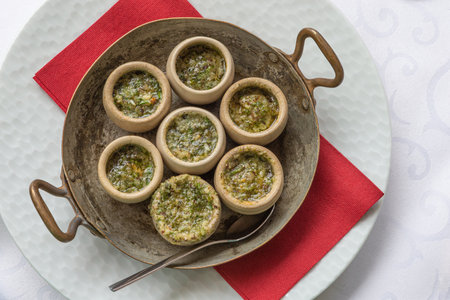 Escargots de Bourgogne - Snails with herbs butter, gourmet dish, in two traditional ceramic pan white background.の写真素材