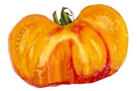 Studio shot of half yellow and orange tomatoes on white backgroundの写真素材