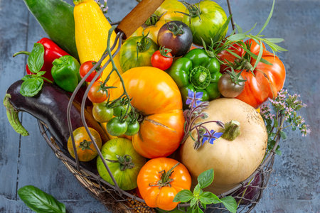 Basket with vegetables (cabbage, carrots, cucumbers, radish and peppers) in the hands of a farmer background of nature Concept of biological, products,の写真素材