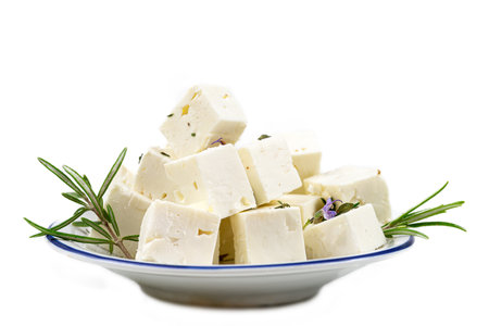 cbes of Feta cheese isolated on white background clipping Heap of Feta cheese, basil leaves and tomatoes.の写真素材