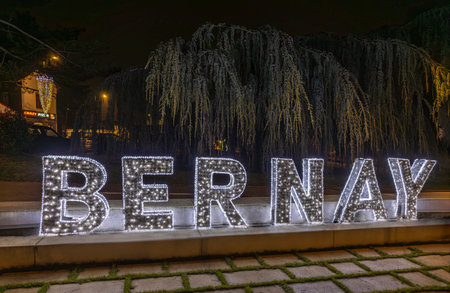 Normandy, France -12- 30- 2024 : Exterior night photo view of christmas light decorations for xmas celebrations decor evening with garlands and tinsel lights,の写真素材