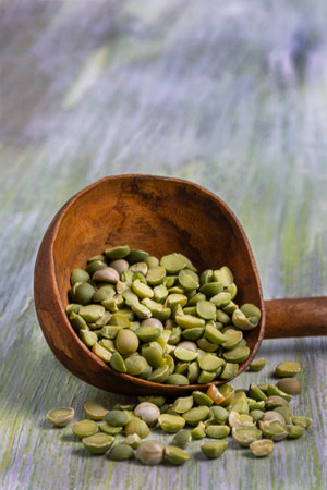 a pile of green split pea on grunge background wooden backgroundの写真素材
