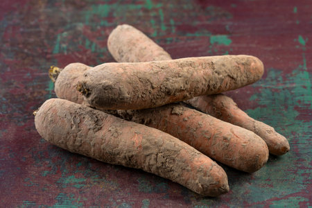 Freshly harvested root vegetables on rustic table