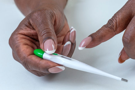 Checking temperature with a digital thermometerの写真素材