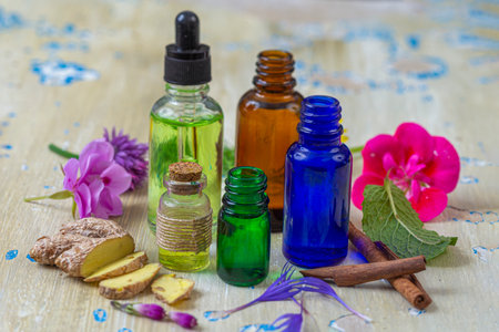 Essential oils and herbs arranged on a tableの写真素材