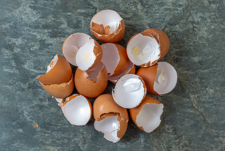 Empty eggshells scattered on a marble counter