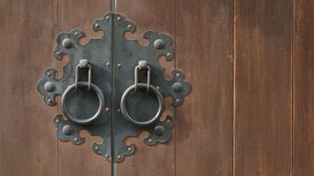 closed wooden doors and steel doorknobs