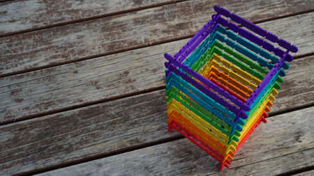 a tower made of rainbow-colored wooden sticks on the tableの写真素材