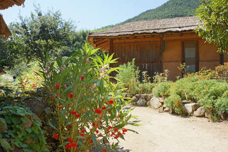 Korean old thatched house with smal gardenの写真素材