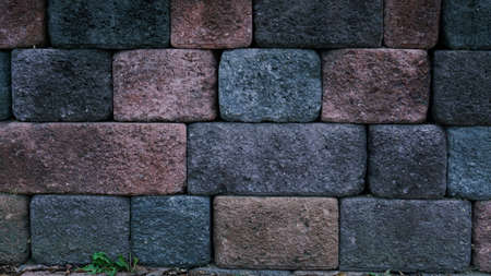 bricks of various dark colors piled up along the sidewalk.の写真素材