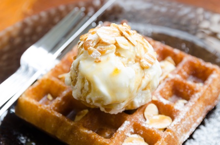 vanilla ice cream scoop on waffle with almond and honeyの写真素材