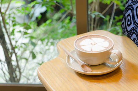 Cup of coffee on the table side of windowの写真素材