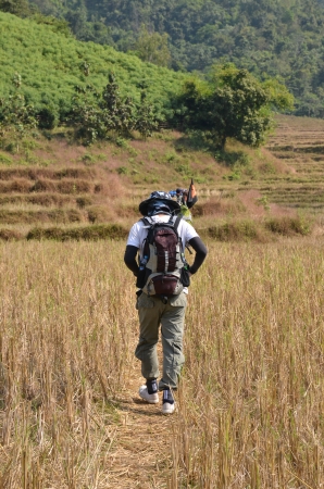 Young man with backpack to hiking summer mountainの写真素材