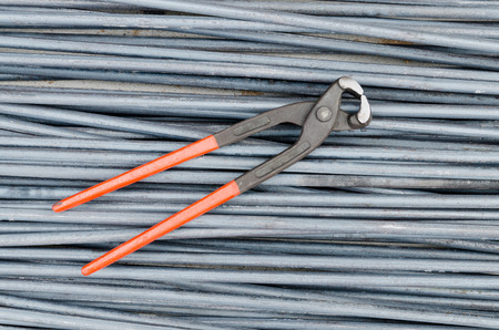 Iron cutting tongs on steel rod