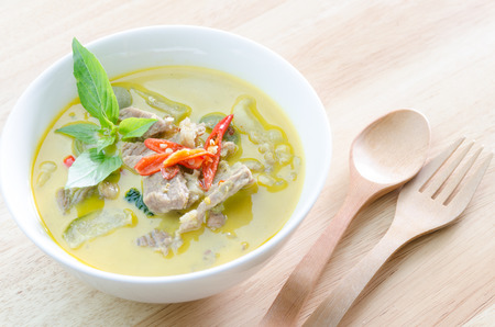 Green curry with pork   and woodden fork spoonの写真素材
