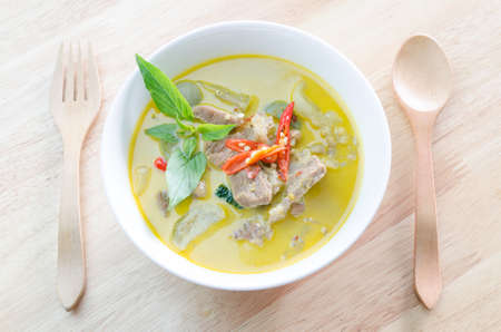 Green curry with pork   and woodden fork spoonの写真素材