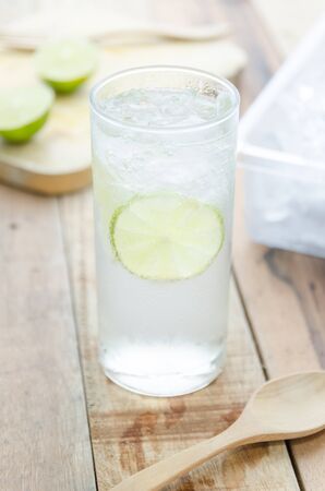 Cool lemon water on wood backgroundの写真素材