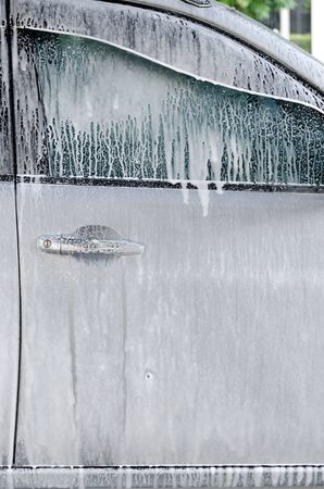 Washing car by foamの写真素材