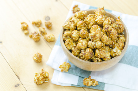 Caramel popcorn in wood bowlの写真素材