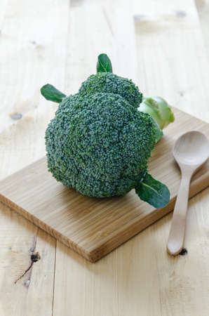 broccoli on wood table and wood spoonの写真素材