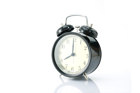 Black alarm clock isolated on whiteの写真素材