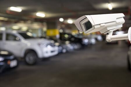 CCTV security camera on blur car parkingの写真素材