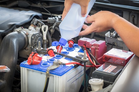 car battery maintenace with distilled waterの写真素材