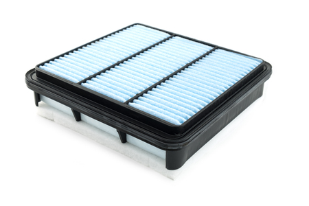 Flat engine air filter in a plastic case on a white backgroundの写真素材