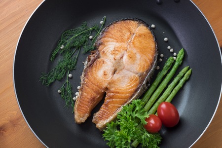 fried salmon in black panの写真素材