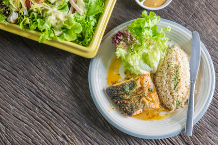 Grilled salmon with rice and saladの写真素材
