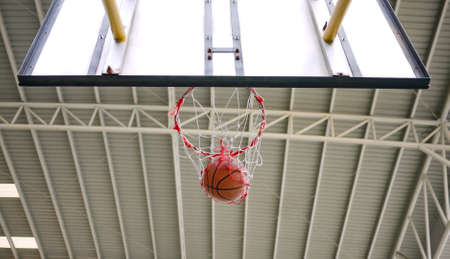 Action shot of basketball going through the hoop