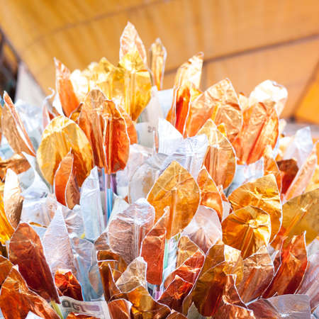 Gold and silver paper, shaped as Bo leaf, attach money to make merit to buddhist priestの写真素材