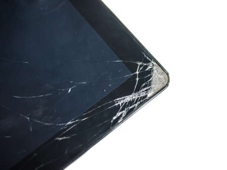 Tablet computer dropped then the glass surface cracked at the corner. Isolated on white background