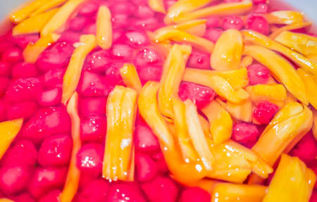 Thai sweet dessert red ruby-like chestnut with jackfruit in syrupの写真素材