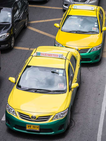 BANGKOK, THAILAND - AUGUST 2, 2013  Photo of Thai yellow-green taxi cab waiting for passenger on the roadのeditorial素材