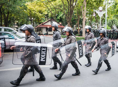 BANGKOK, THAILAND - NOVEMBER 11, 2013  Policemen patrol inside the police headquarter to keep this place secured from protesters のeditorial素材