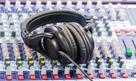 Headphone placed on mixer symbolize of sound engineer and dj occupationの写真素材