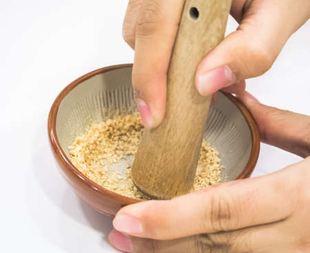 Hand pounding white sesame as for making japanese dipping sauceの写真素材