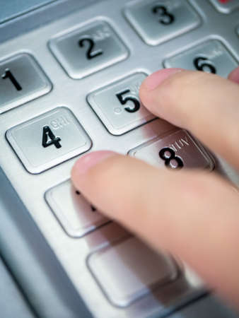 Finger pressing metallic numpad concept of financial business