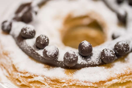 Macro shot of chocolate doughnut with sugar icingの写真素材