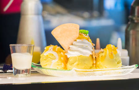 Yellow ice creams prepared to be served in glass plateの写真素材