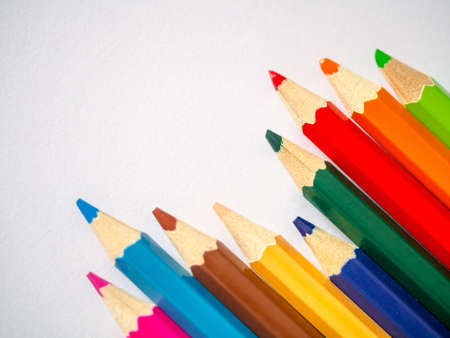 Colored pencil isolated on grey textured art paper arranged at the cornerの写真素材