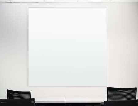 Blank square board on the white wall in officeの写真素材