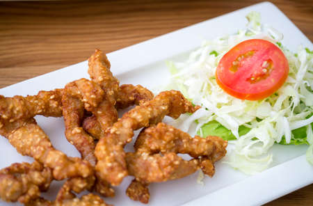 Pork fried with sesame served with fresh vegetables as an appetizerの写真素材